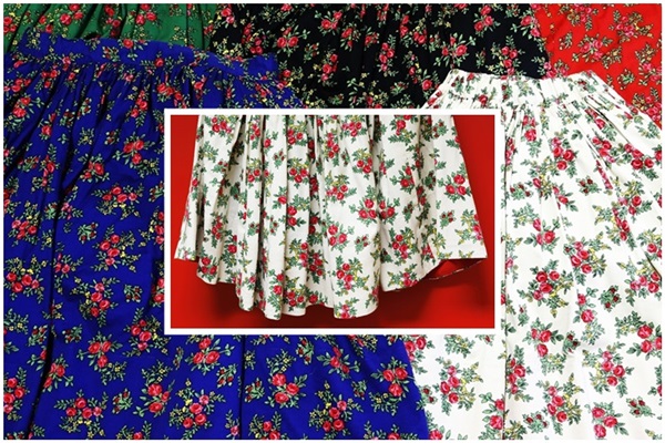 Zdjęcie strojów ludowych. Spódnice w różnych kolorach w kwiaty.